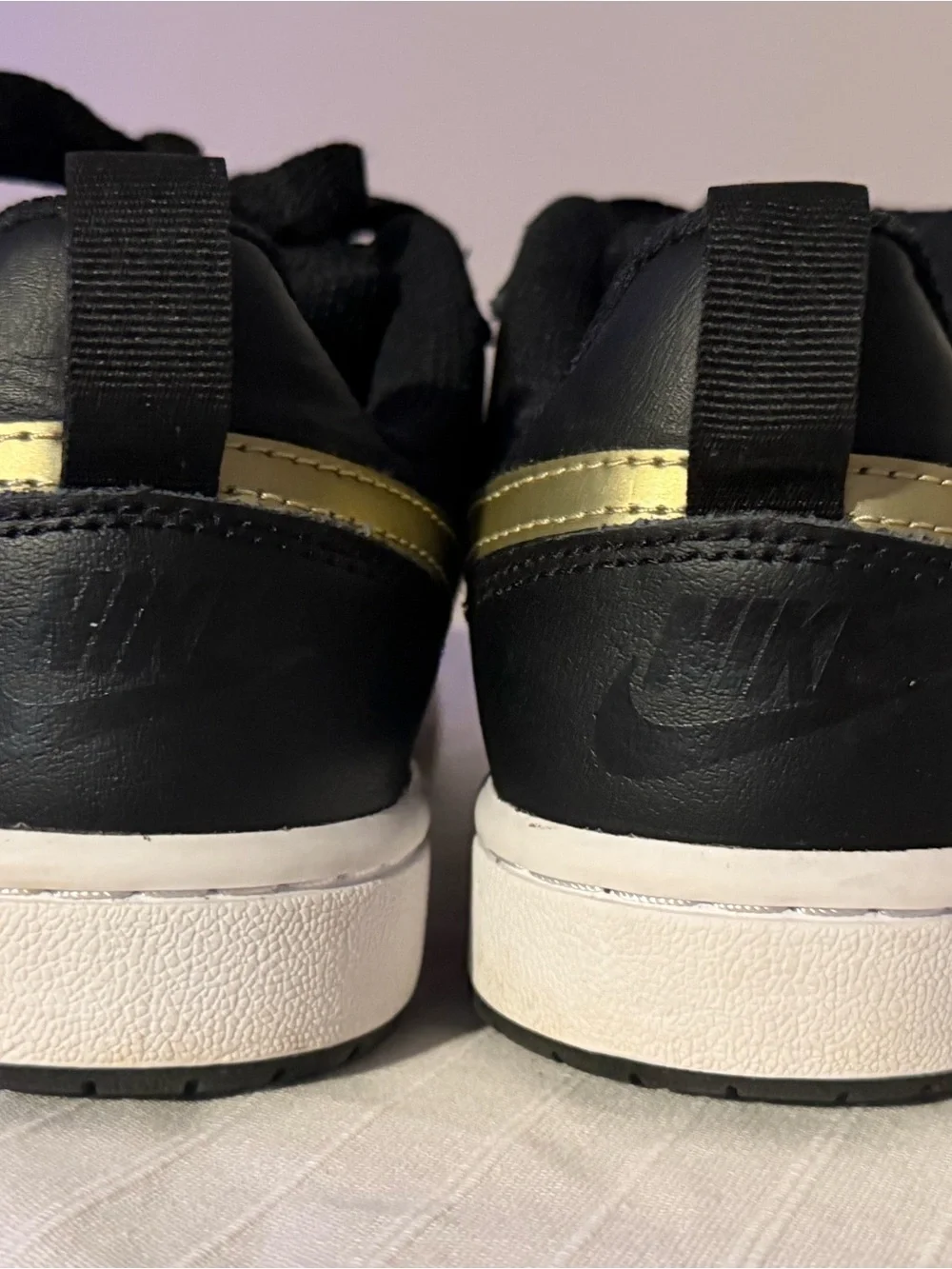 Nike Kids Black Sneakers with Gold Swoosh